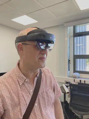 A visitor trying a mixed-reality headset at the lab inauguration