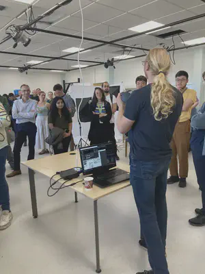 A presenter demonstrating XR equipment to attendees at the lab inauguration